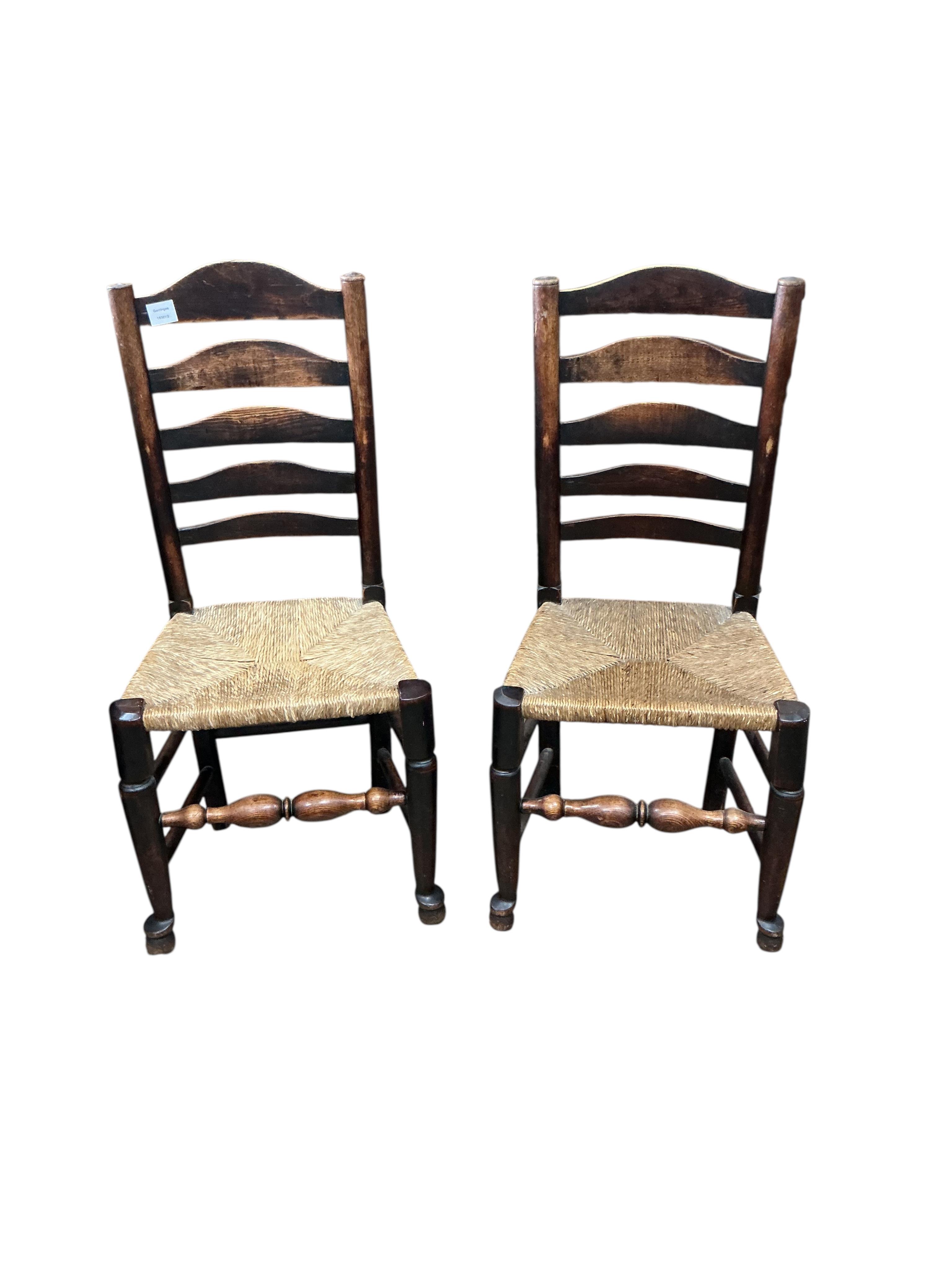 A harlequin set of six 19th century Provincial ladderback dining chairs, one with arms